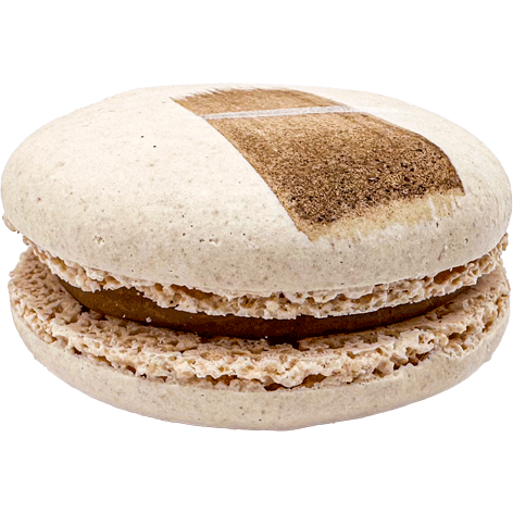 A light coloured macaron with a painted swipe of chai