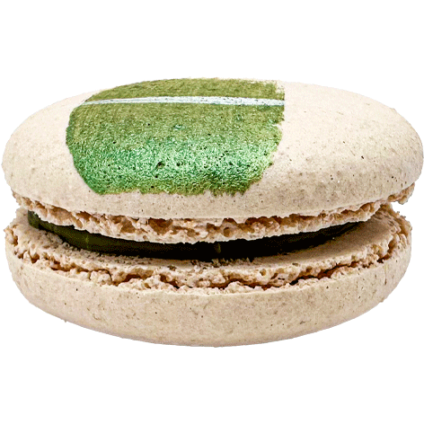 A light coloured macaron with a painted swipe of green and a dark green filling